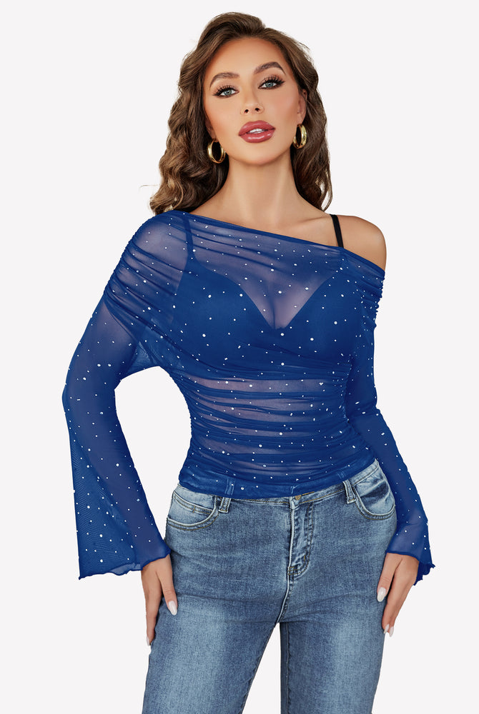 Blue mesh off-shoulder top with rhinestone accents, long bell sleeves, and jeans, a stylish look.