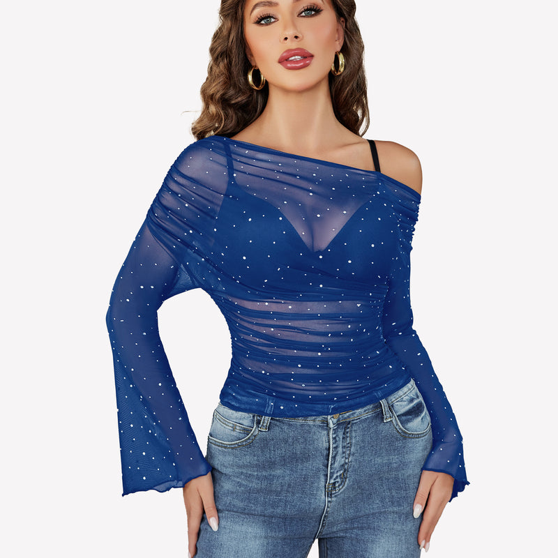 Blue mesh off-shoulder top with rhinestone accents, long bell sleeves, and jeans, a stylish look.