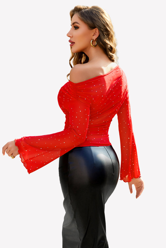 Red mesh off-shoulder top with rhinestone accents, bell sleeves, and black skirt, a stylish look.