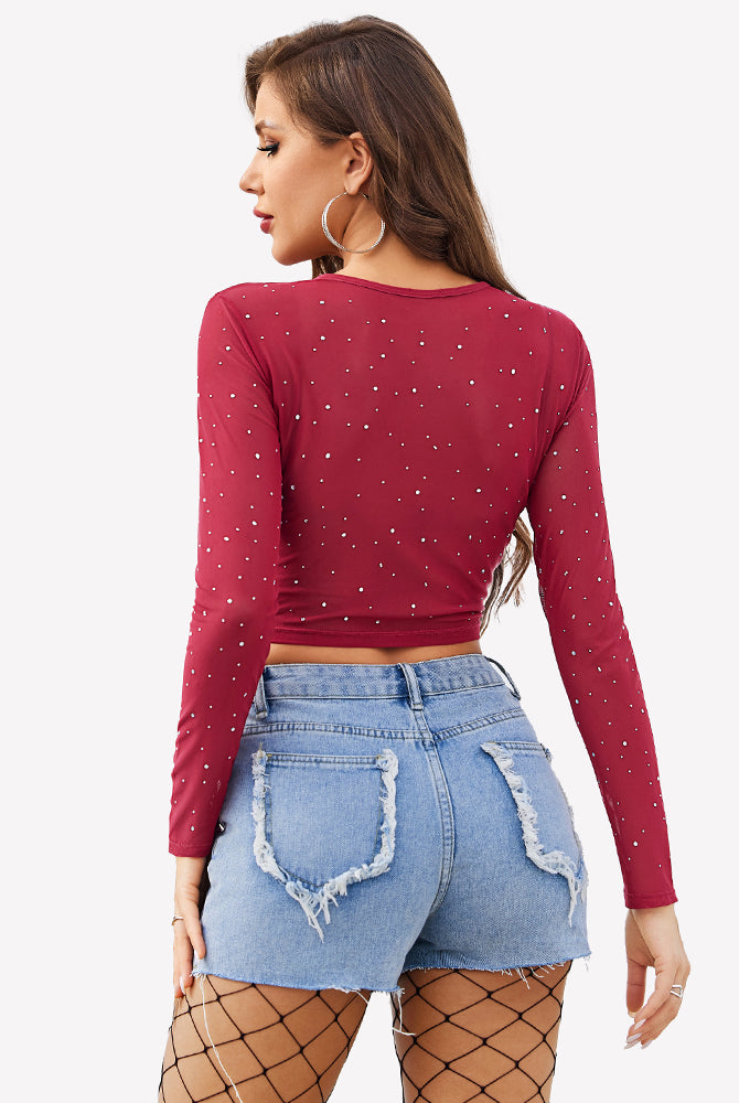 Burgundy rhinestone mesh crop top with long sleeves and blue denim shorts. Sexy lingerie.