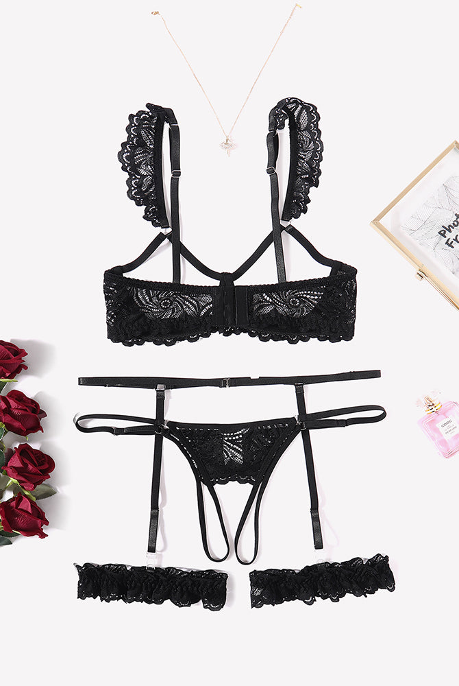 Black lace lingerie set: bra, garter belt, thong, and leg rings. Romantic nightwear.