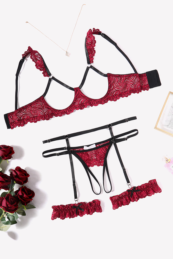 Red floral lace lingerie set with garter belt, bra, and panty, perfect for a romantic night.