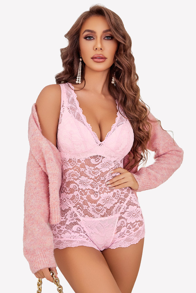 Pink lace short bodysuit with deep V-neck and floral design, confident look.