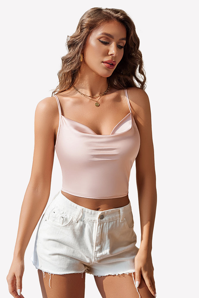 Pink silk satin camisole Y2k tank top with spaghetti straps and white shorts. Modern and stylish.