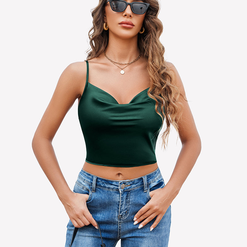 Green silk satin camisole Y2k tank top with spaghetti straps and blue jeans. Stylish.