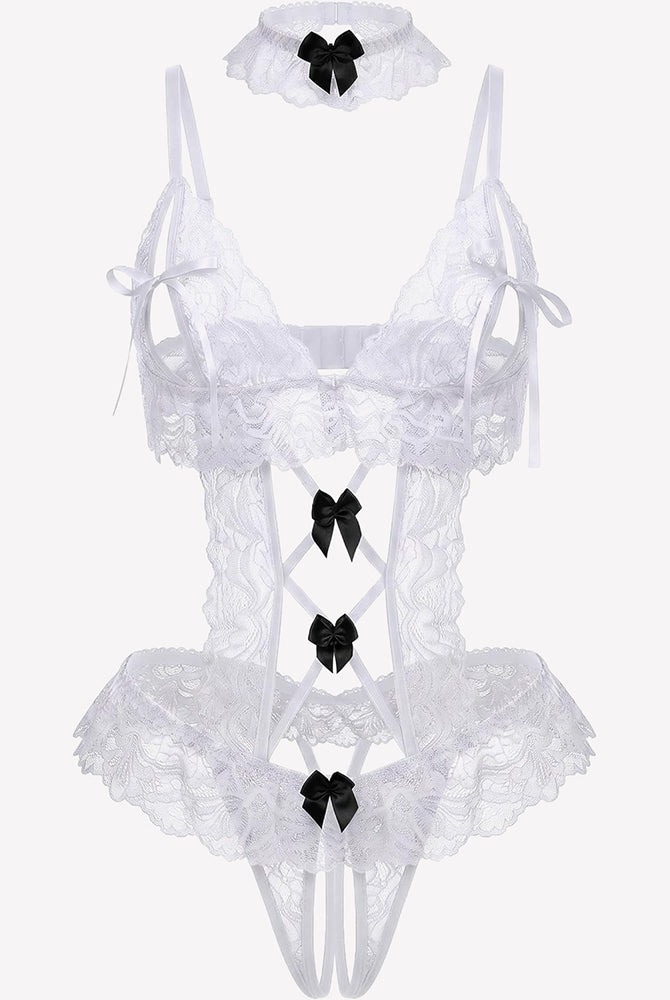 White lace bodysuit teddy flat lay with black bows, lace garters, and thong cut