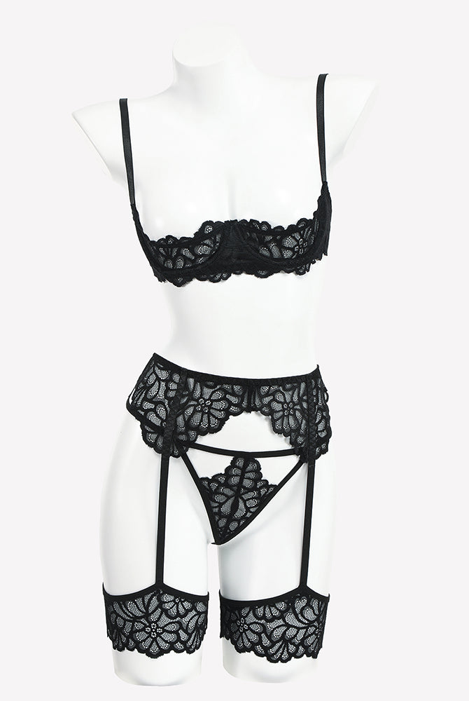 Black lace lingerie set on mannequin: lace bra, garter belt, and lace thong with straps