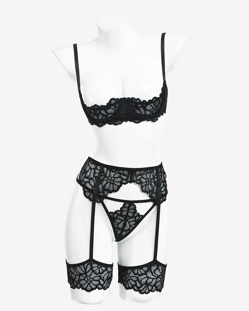 Black lace lingerie set on mannequin: lace bra, garter belt, and lace thong with straps