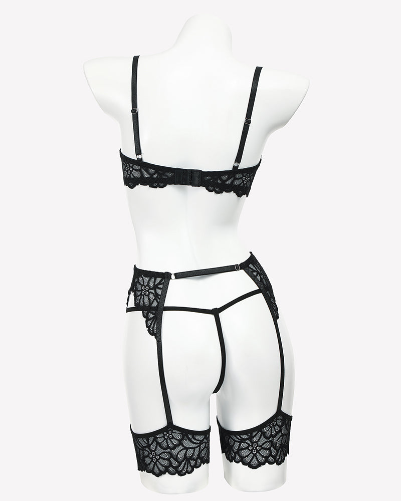 Black lace lingerie set on mannequin: lace bra, garter belt, thong, and thigh straps