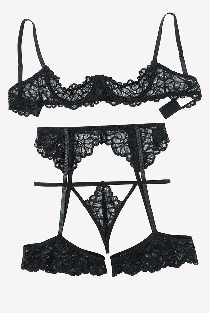 Black lace lingerie set flat layout: lace bra, garter belt, thong, and garter straps