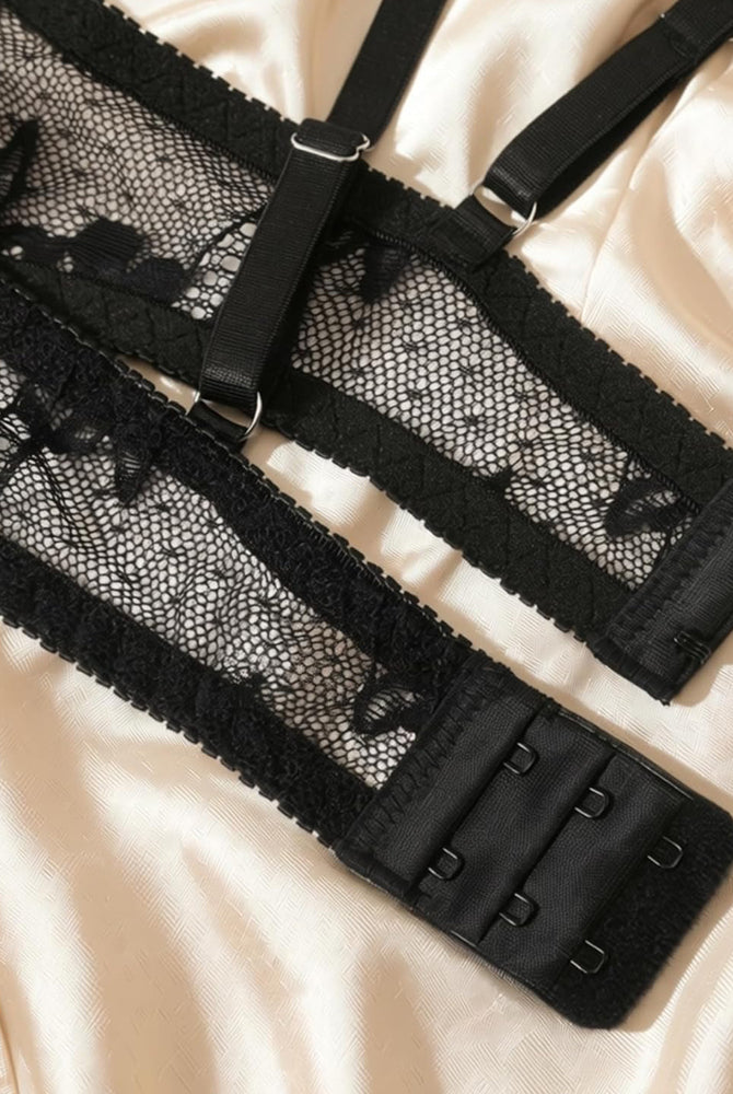 Black lace lingerie set: adjustable bra straps and hook-and-eye band close-up