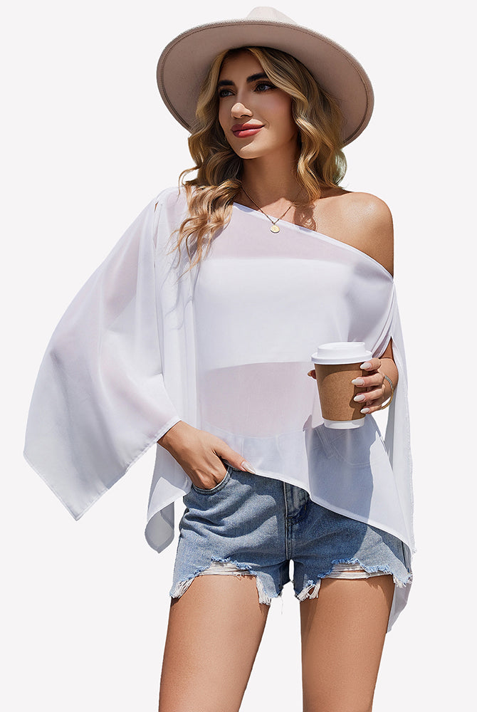 Off-shoulder chiffon blouse in white, flowy batwing sleeves and loose drape.