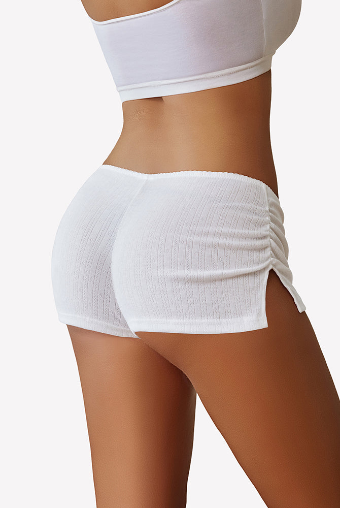 White low rise lounge shorts from back view with side slit and drawstring waist