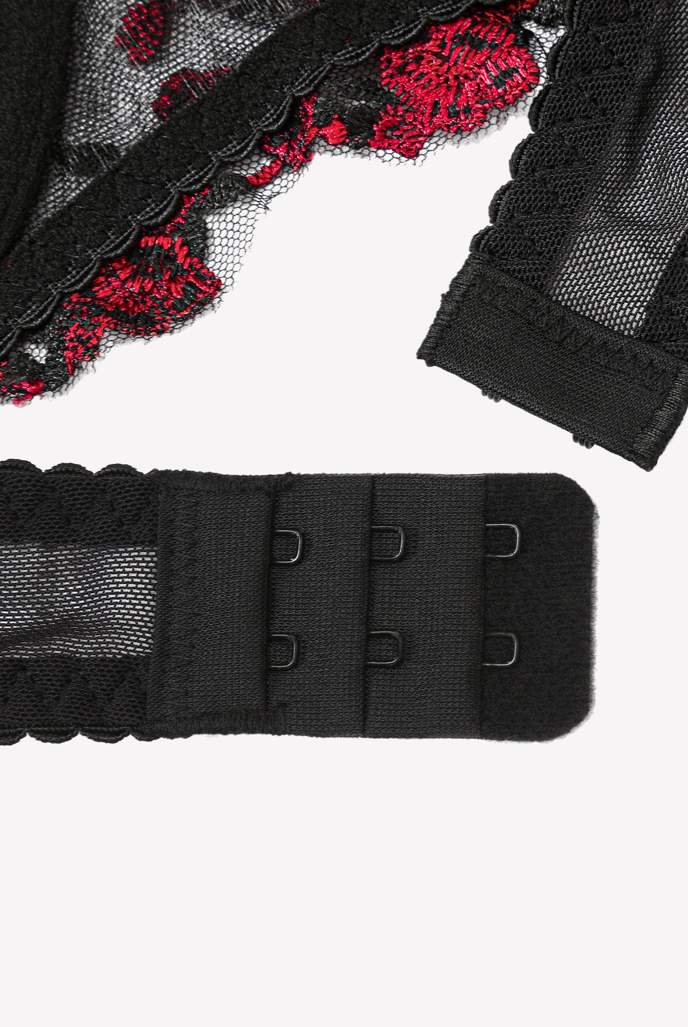 Black bra back band with adjustable hooks, red floral lace trim, close-up