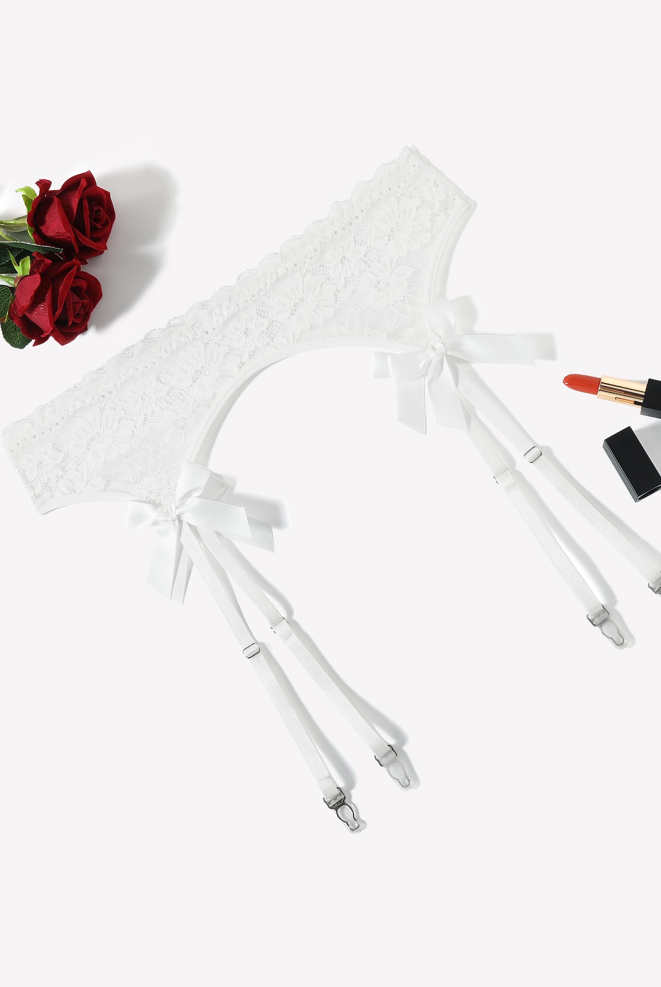 White lace garter belt with four adjustable suspender straps and bow ties