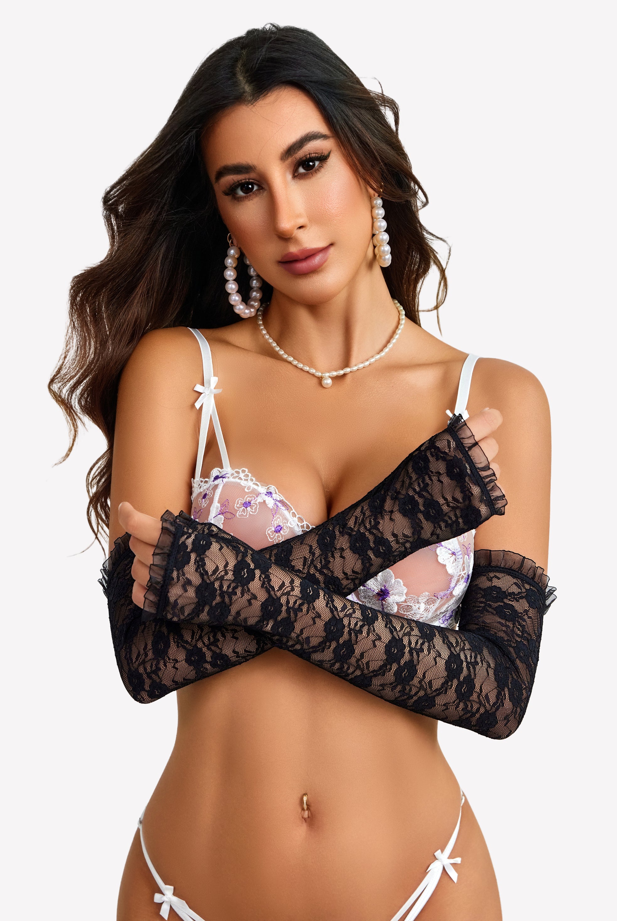 Long black lace fingerless gloves with frilled cuffs on model, sheer forearm coverage