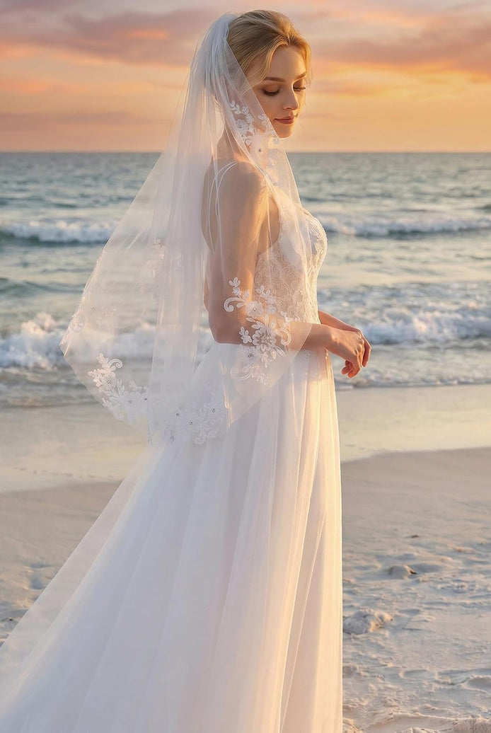 White fingertip-length bridal veil with scalloped lace edge and comb