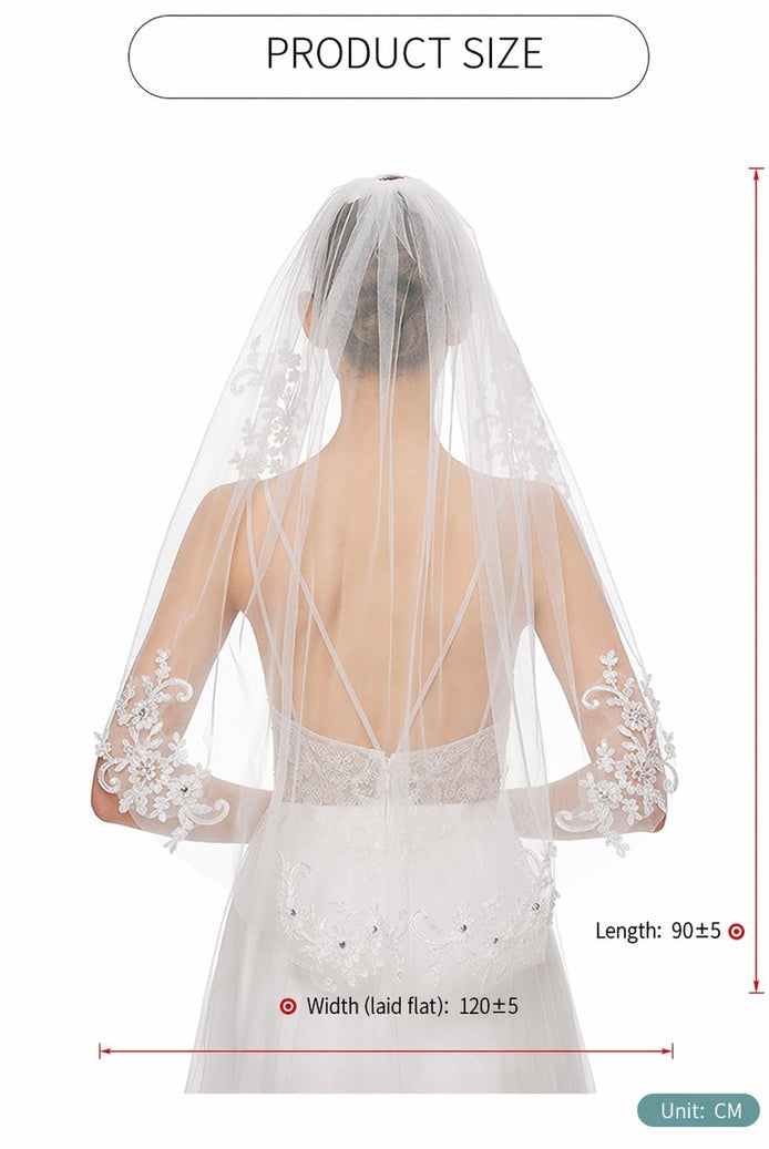 White fingertip veil with scalloped lace trim, product size diagram behind