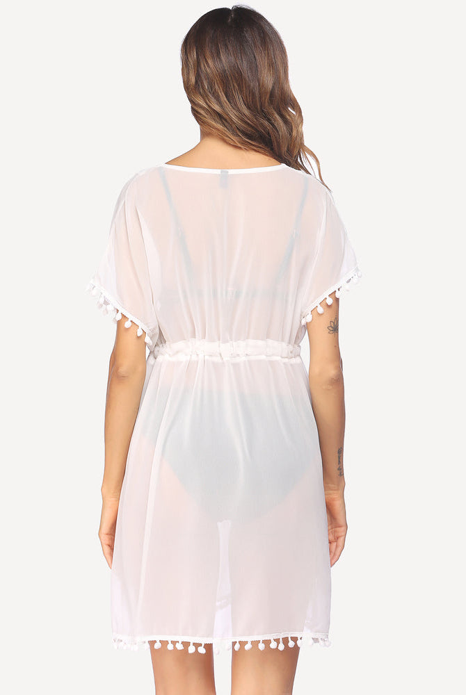 White sheer swimsuit cover-up with tassels and drawstring waist. Lightweight and stylish beachwear