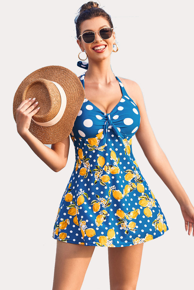 Retro tankini swimsuit with lemon print, sun protection, and skirted bottom. Halter neck swimwear