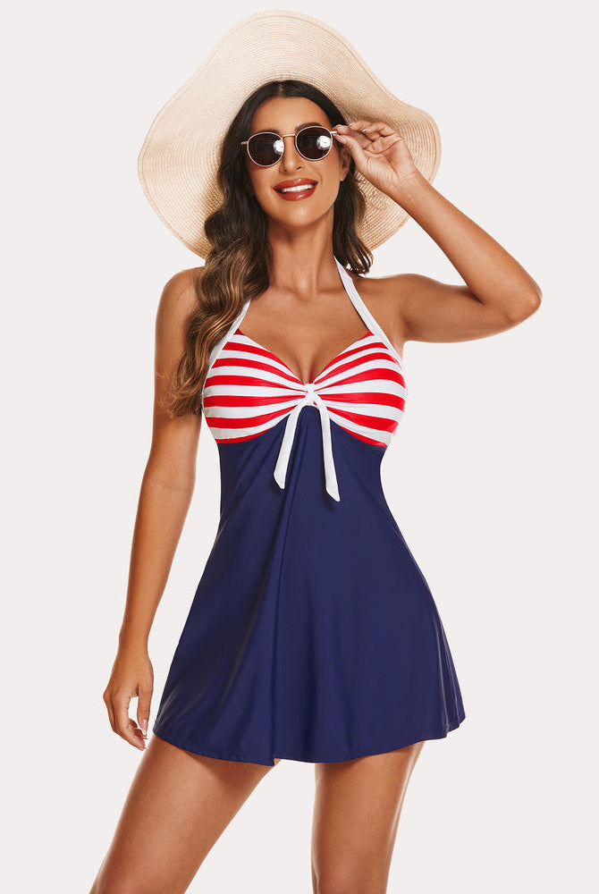 Navy blue striped halter tankini swimdress. Two-piece swimwear with sun hat, flattering design.