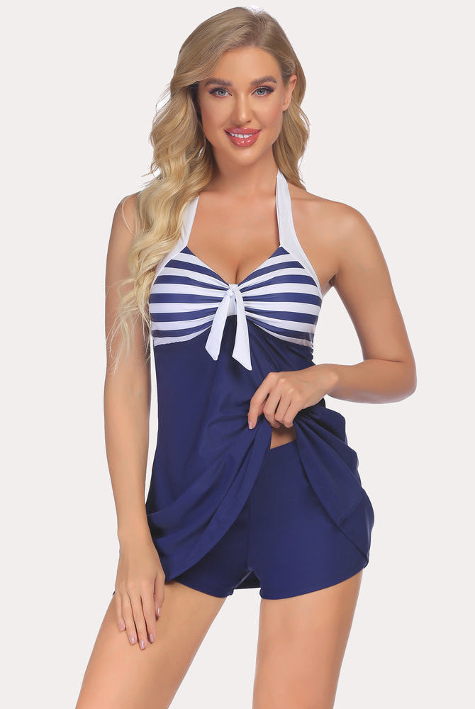 Navy retro tankini set with sailor stripe top and skirted shorts. Sun-protective swimwear.