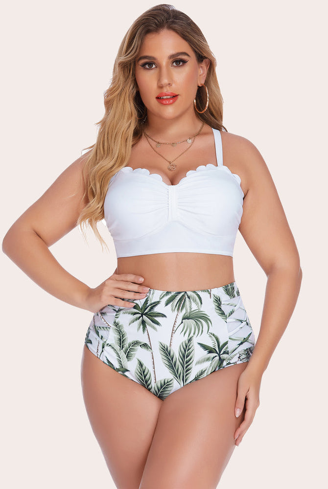 Plus size high-waisted bikini set featuring white scalloped top and palm tree print bottom