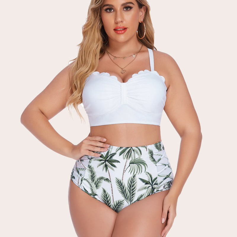 Plus size high-waisted bikini set featuring white scalloped top and palm tree print bottom