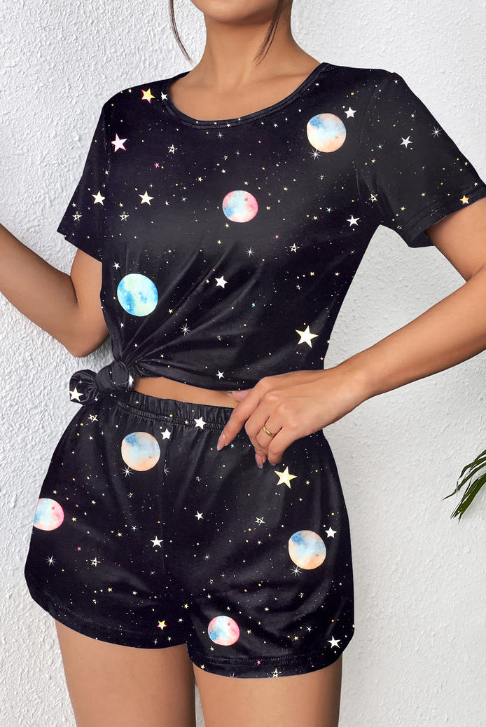 Black short-sleeve pajama set with colorful planet and star print; matching shorts