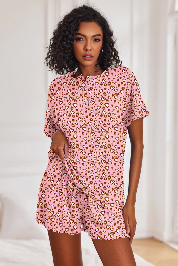 Pink leopard print short-sleeve pajama set with button-front top and matching drawstring shorts