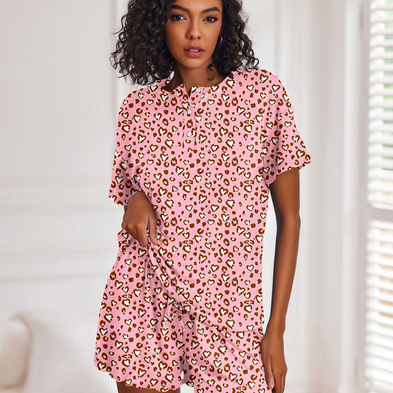 Pink leopard print short-sleeve pajama set with button-front top and matching drawstring shorts