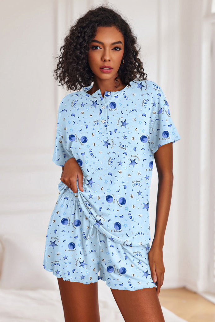 Women's light blue galaxy-print short-sleeve pajama set with button top and drawstring shorts