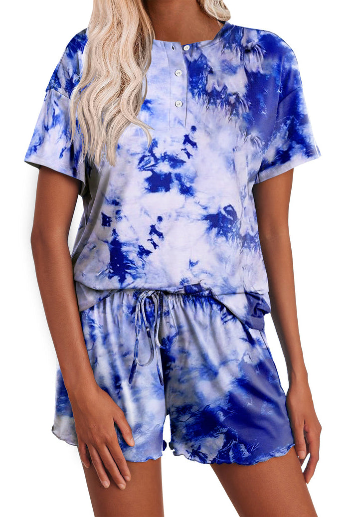 Women’s tie-dye pajama set in blue; short-sleeve button henley top with matching drawstring shorts