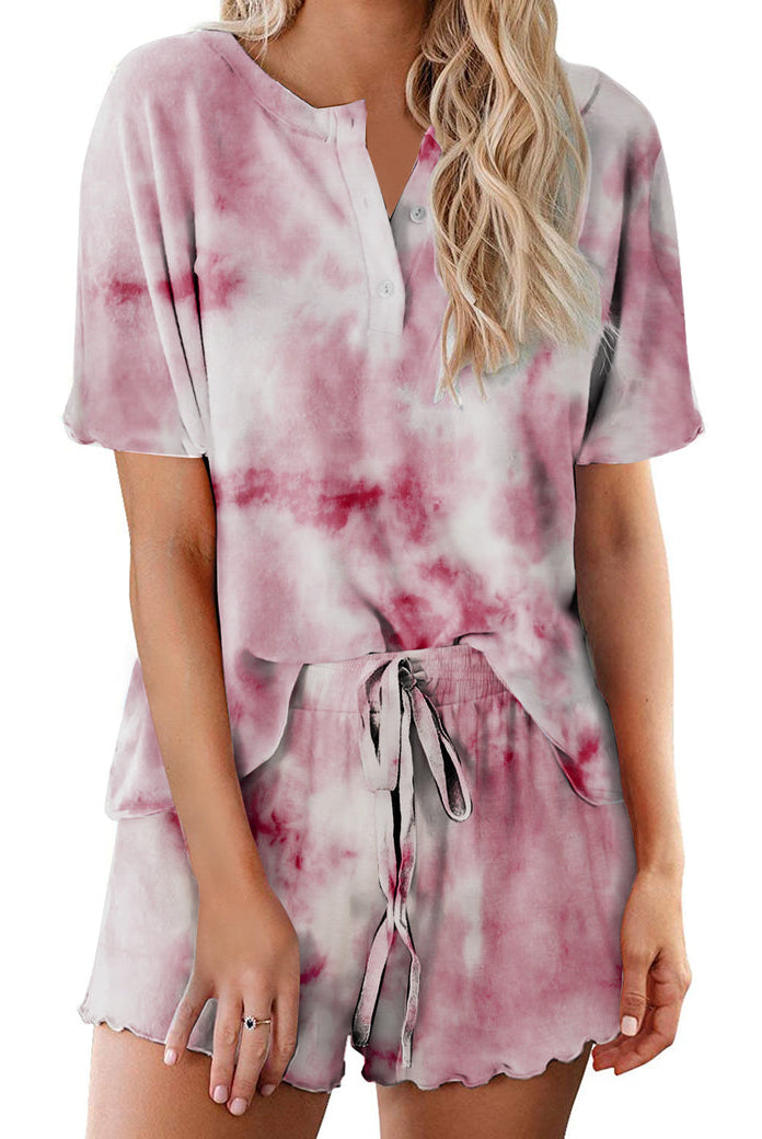 Women’s tie-dye pajama set in pale pink with darker pink clouds; short-sleeve button top and drawstring shorts
