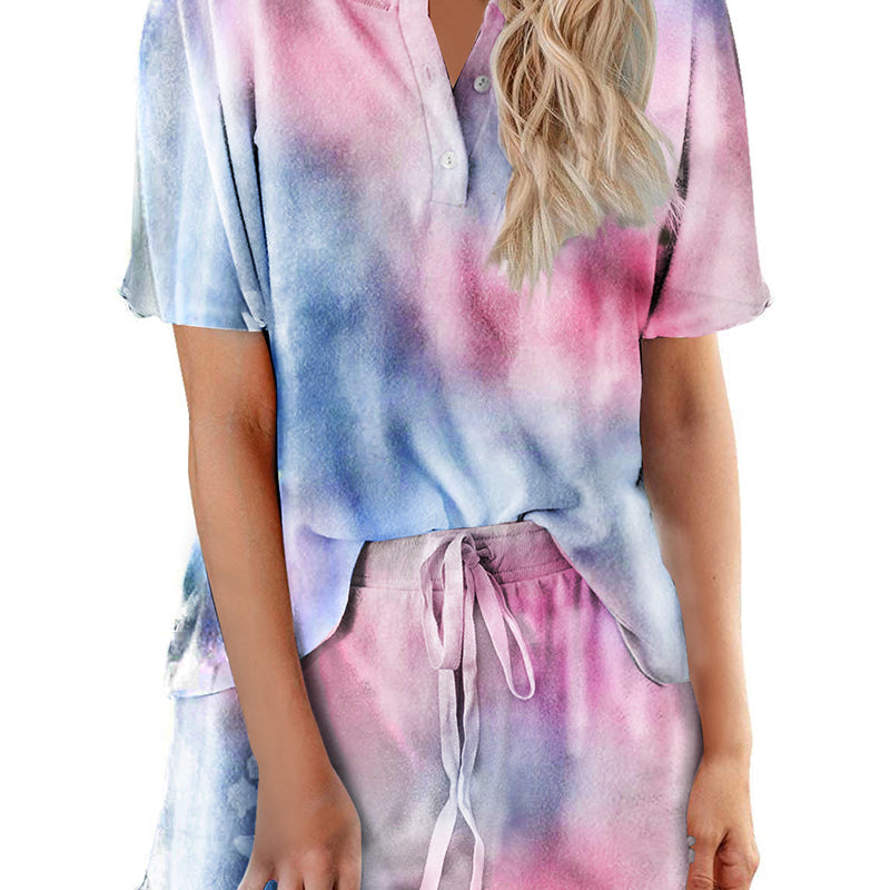 Women’s tie-dye pajama set in purple, blue, and pink; short-sleeve button top with drawstring shorts