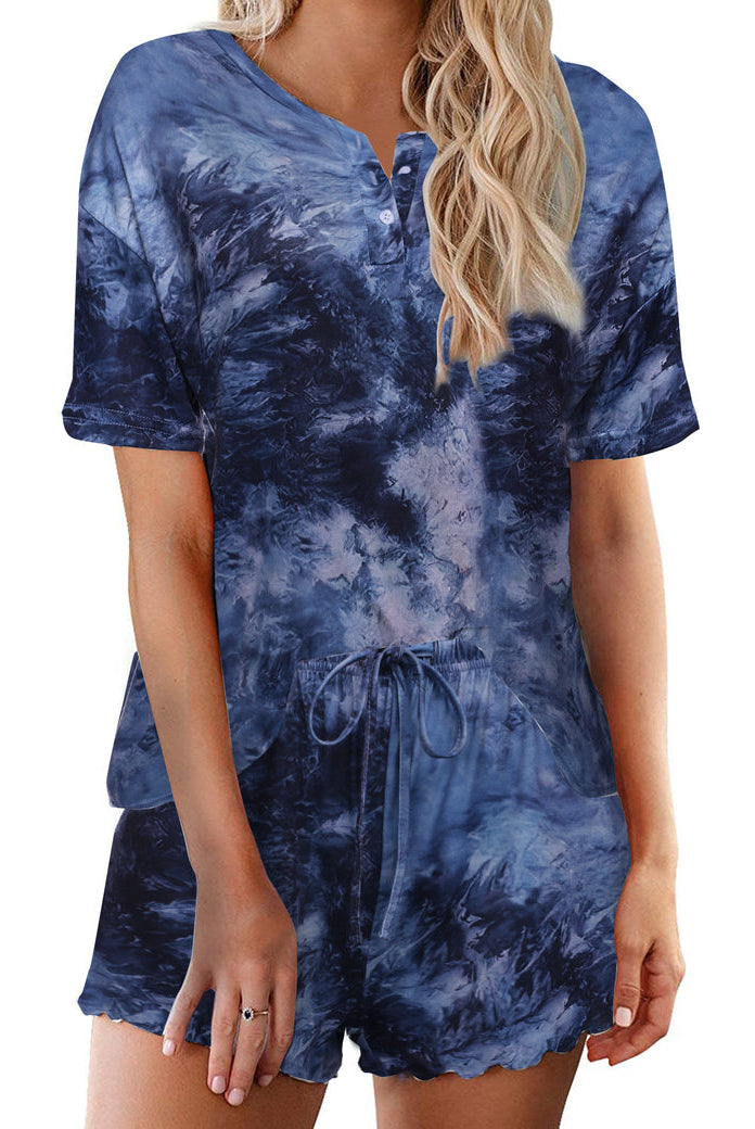 Women’s tie-dye pajama set in deep blue; short-sleeve button henley top with matching drawstring shorts