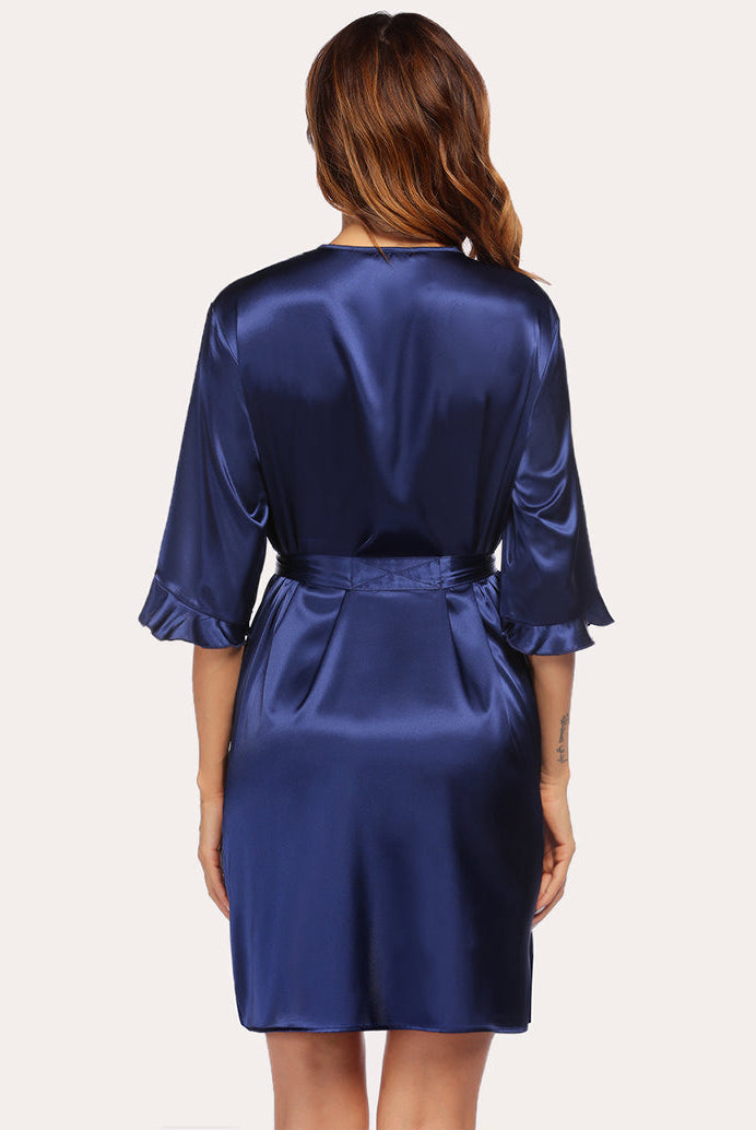 Back view of navy blue satin robe with tie belt and V-neck wrap styling.