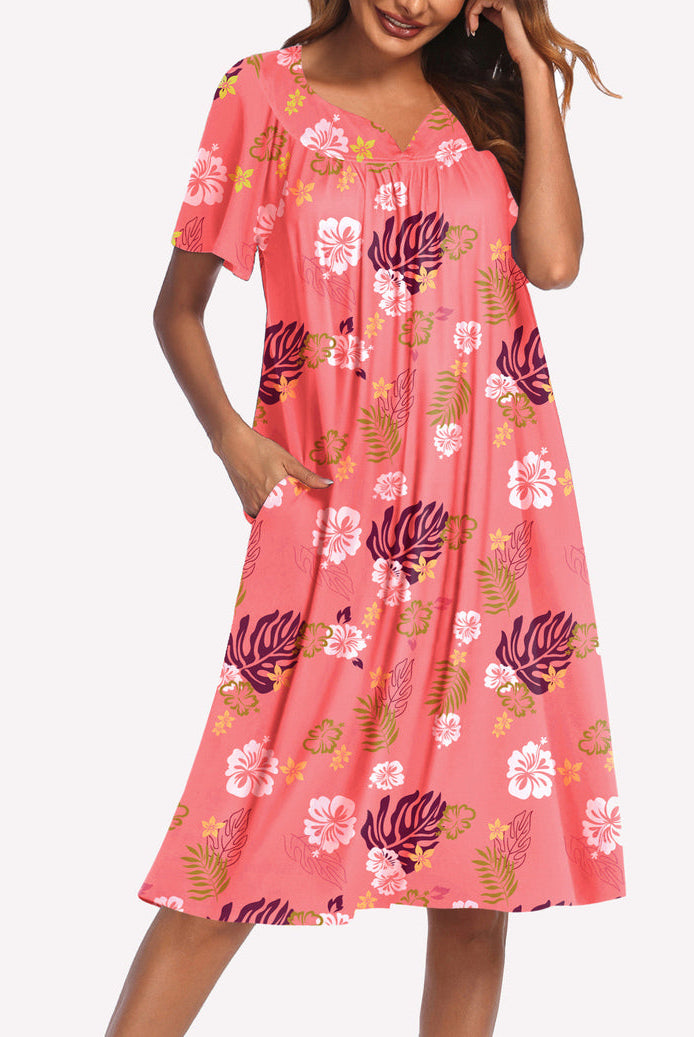 Short-sleeve lounger nightgown in pink with colorful floral and leaf print, V-neck and gathered bodice.