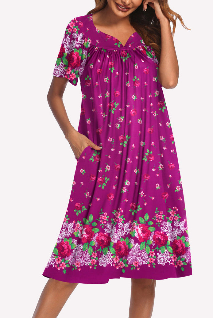 Short-sleeve lounger nightgown in magenta with green and pink floral print, V-neck and gathered waist.