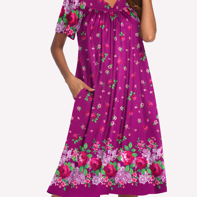 Short-sleeve lounger nightgown in magenta with green and pink floral print, V-neck and gathered waist.