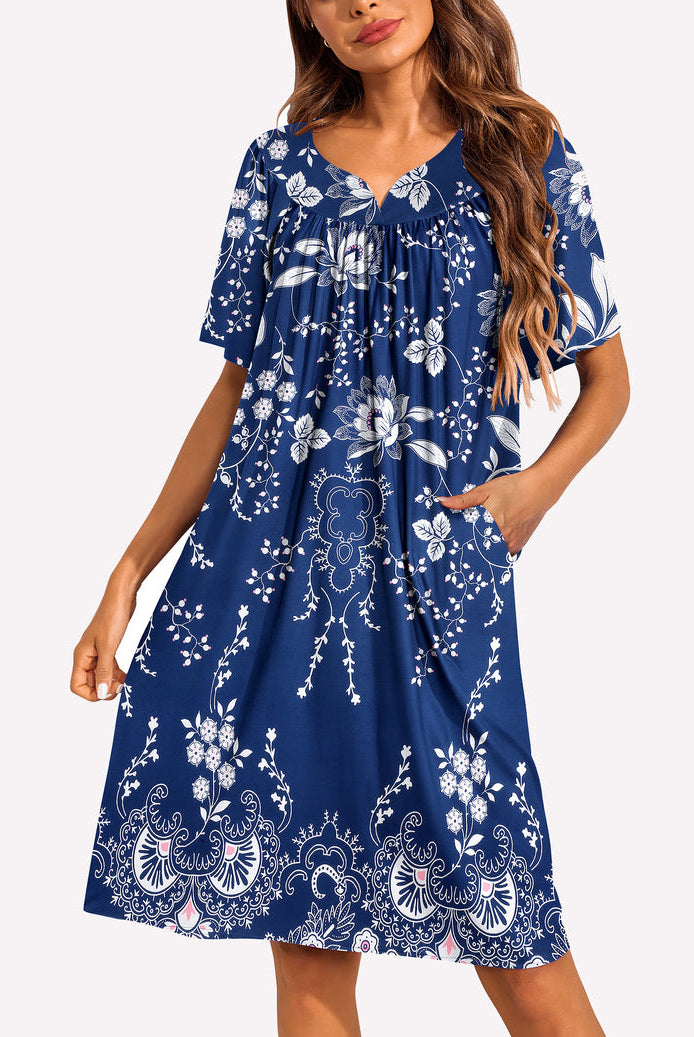 Short-sleeve lounger nightgown in blue with white floral and paisley print, gathered V-neck.