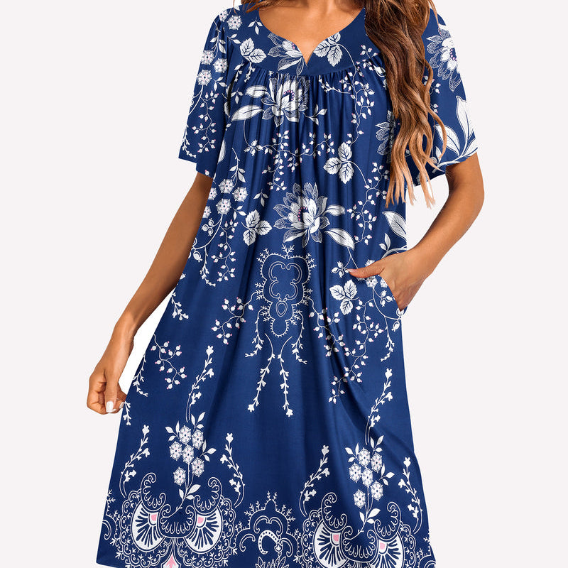 Short-sleeve lounger nightgown in blue with white floral and paisley print, gathered V-neck.