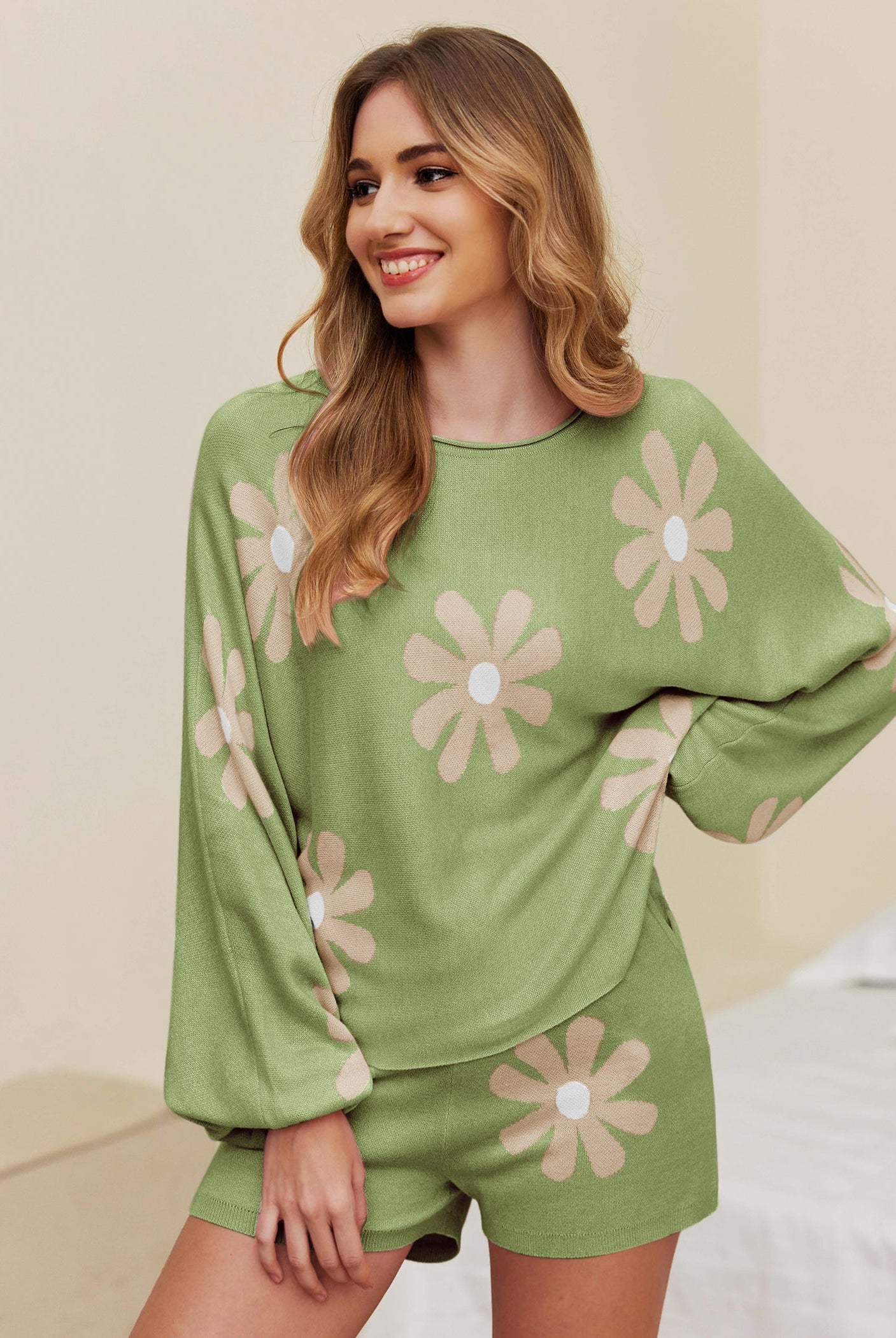 Green pajama set with long sleeves and shorts, white daisy print and elastic waistband