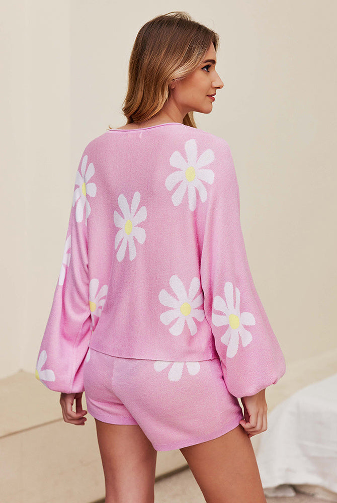 Pink pajama set with long sleeves and shorts, all-over daisy print, back view