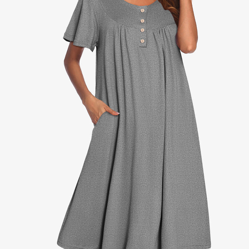 Women’s short sleeve grey henley dress with button placket and gathered yoke.