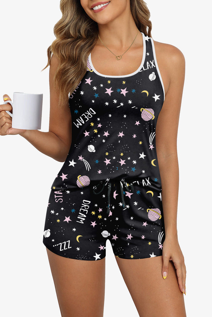 Women’s pajama set with dark star-and-space print cami and matching drawstring shorts