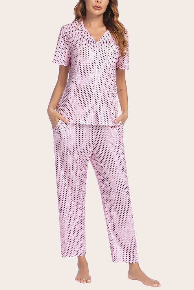 Pink polka dot notch collar short sleeve pajama set with button-down top and long pants.