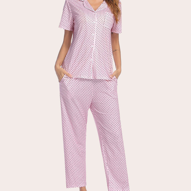 Pink polka dot notch collar short sleeve pajama set with button-down top and long pants.