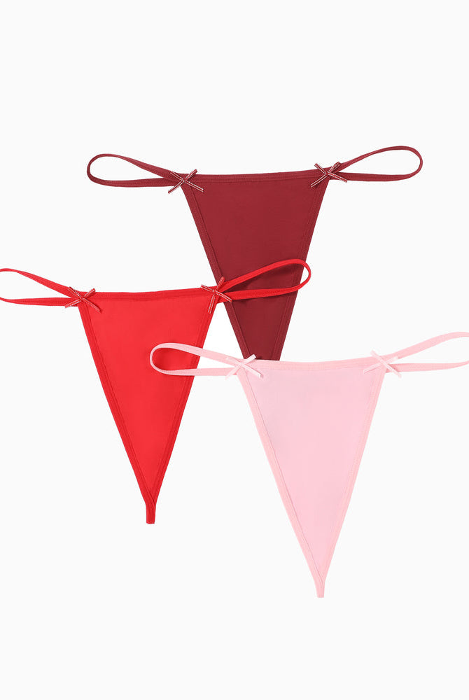 Avidlove G-string thong 3-pack in red, burgundy, and pink. Sexy lingerie with bow details.