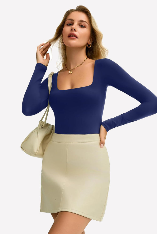 Navy blue square neck bodysuit, ultra-stretchy, shows off bodyline, paired with a cream skirt.